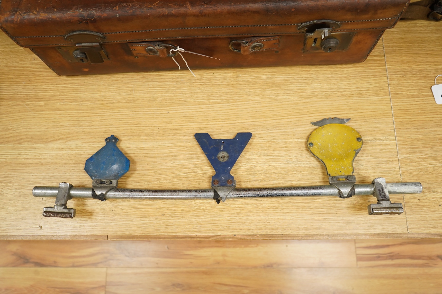 Three car badges to include RAC and AA, mounted on a bar, 67cm in length